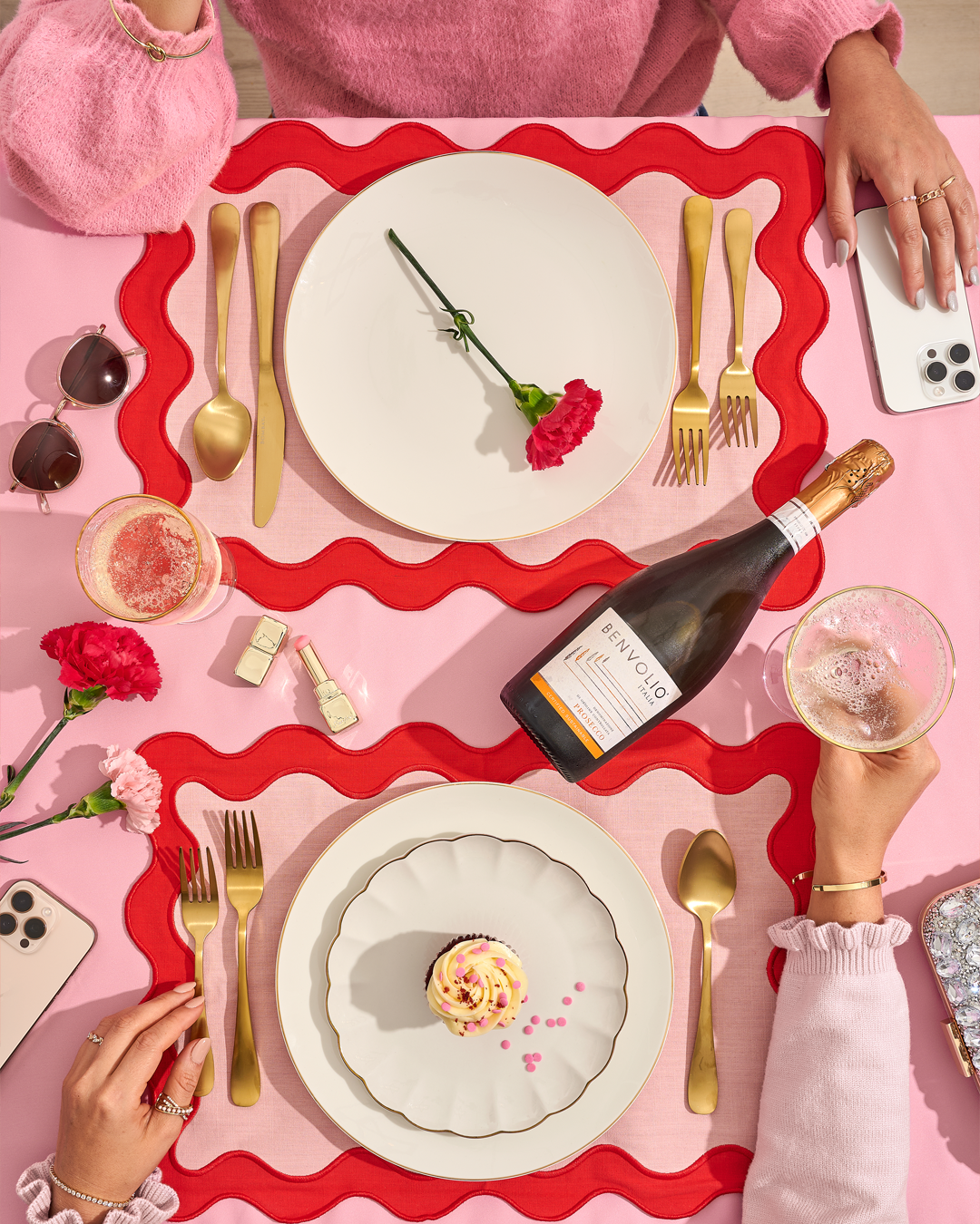 Yellow gingham with three people picnicking and a bottle of Benvolio Prosecco.